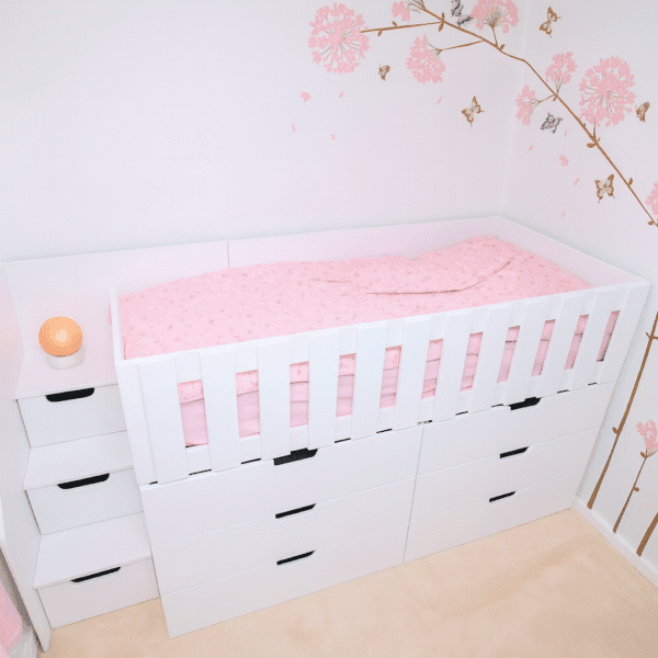 High Sleeper bed with stairs and drawers in the stairs. 6 deep drawers under bed with pink tree mural on the wall.