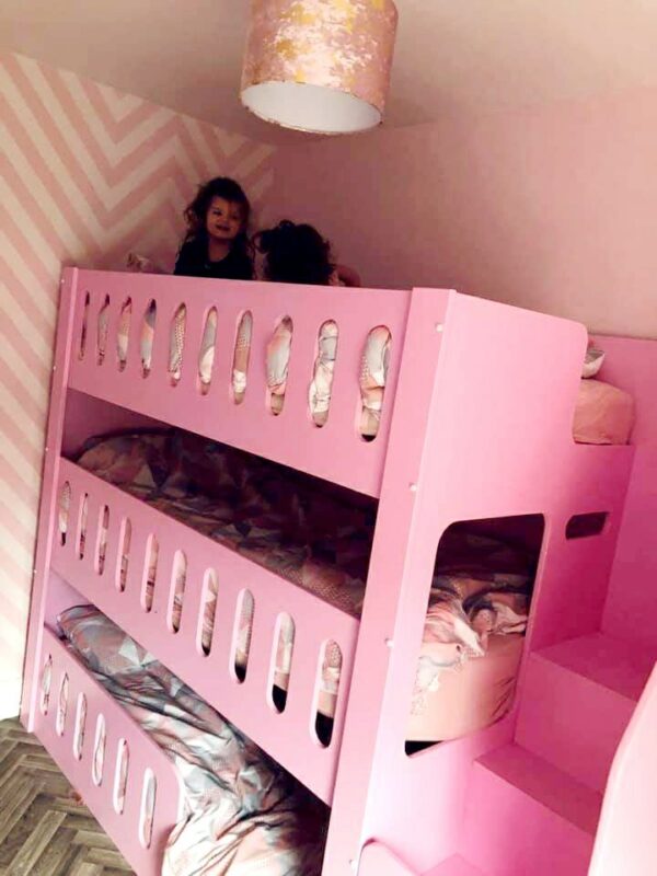 triple tier bunk in pink. bunk bed. drawers in the stairs. funky bunk beds. bunk bed with stairs