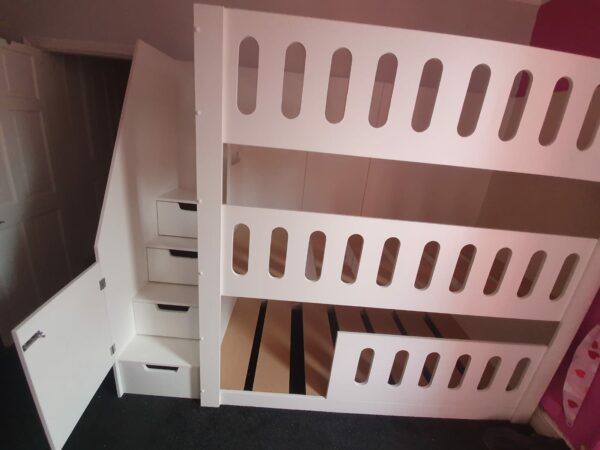 triple tier bunk in white. bed guard drawers in the stairs. funky bunk beds. bunk bed with stairs. gate on the stairs