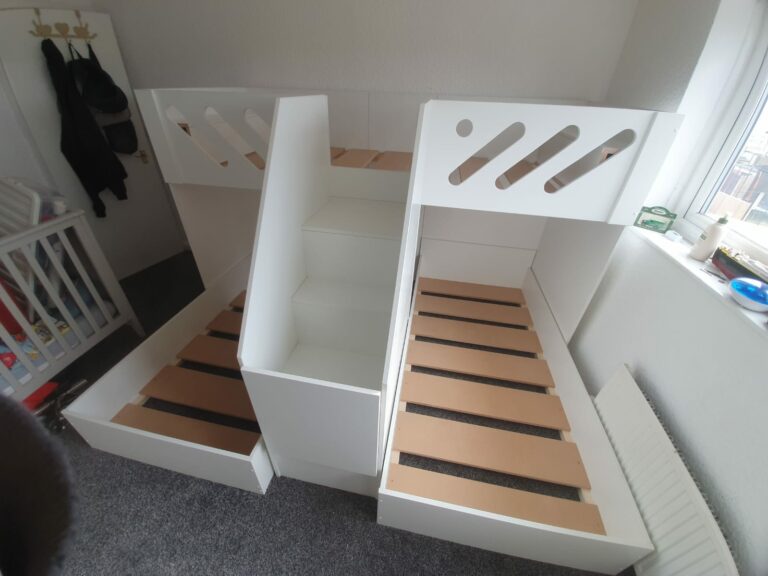 m shape triple bunk with gate on the stair case. in white. funky bunk beds design. single mattress size.