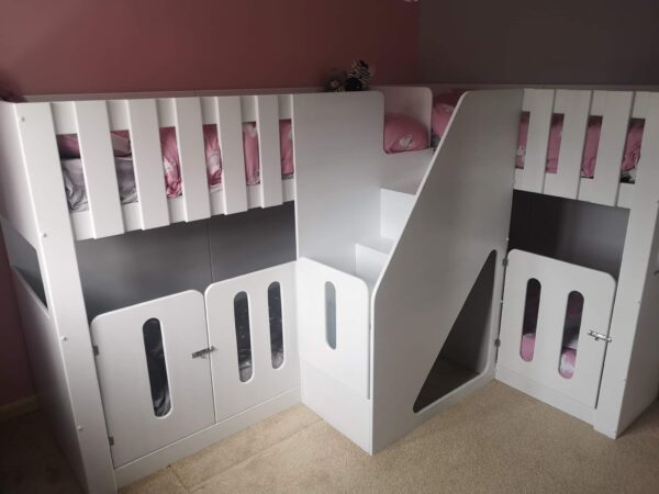 corner L Shape quad sleeper, stairs on the front. carpet on the stairs. sleep four. bespoke bunk beds. gate on the stairs. cot rail.