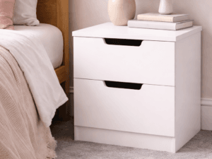 POLAR bedside cabinet with two drawers and recessed handles displayed beside a bed